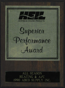 A wooden plaque with the words superior performance award.